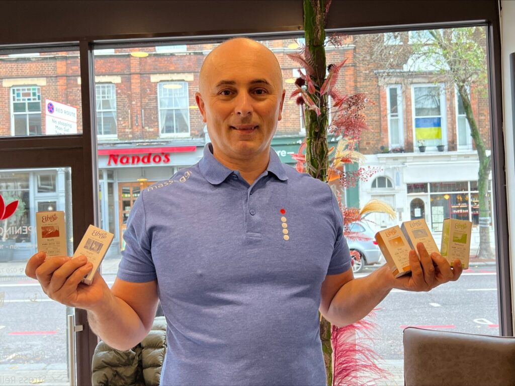 CBD Massage. Ben Massaggi holding EthicaCBD products.